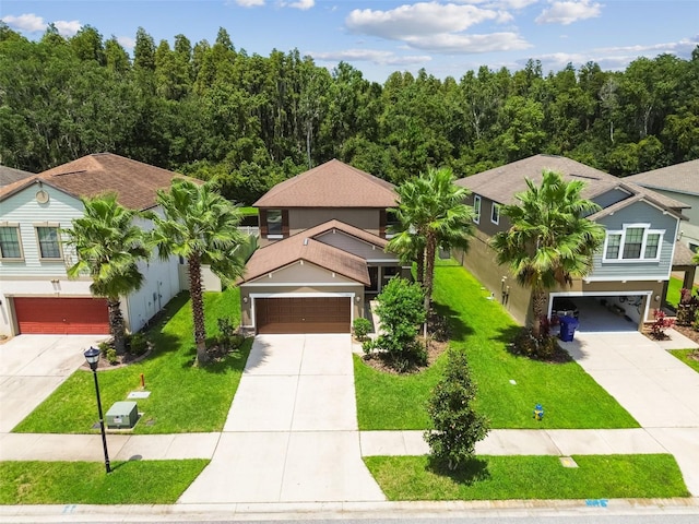 view of front of home with a front lawn and a garage