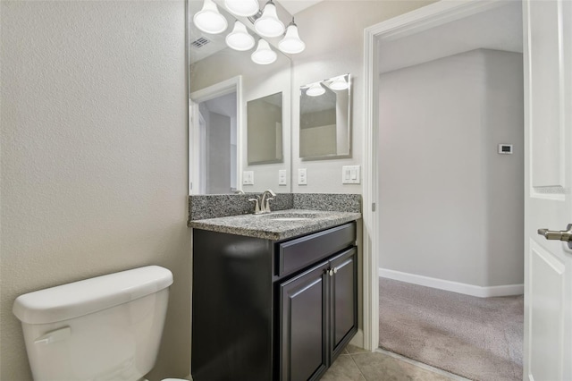 bathroom with tile patterned floors, vanity, and toilet