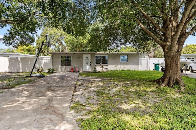 ranch-style home with a front lawn