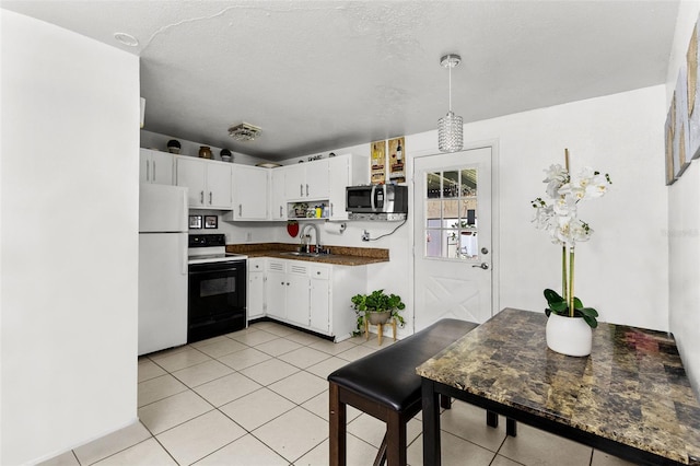 kitchen featuring light tile patterned floors, sink, electric range, white refrigerator, and white cabinets