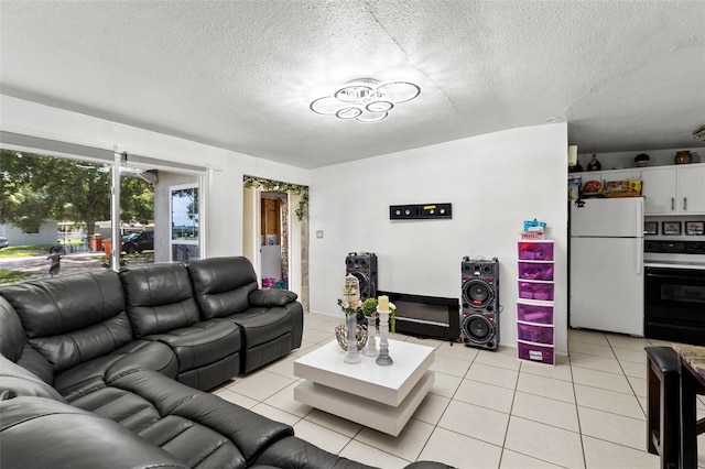 living room with a textured ceiling and light tile patterned flooring