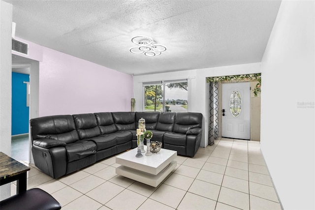 living room featuring a textured ceiling and light tile patterned flooring