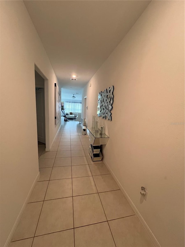 hall featuring light tile patterned flooring