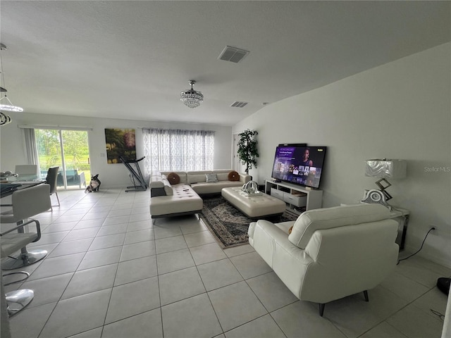 tiled living room featuring a textured ceiling and lofted ceiling