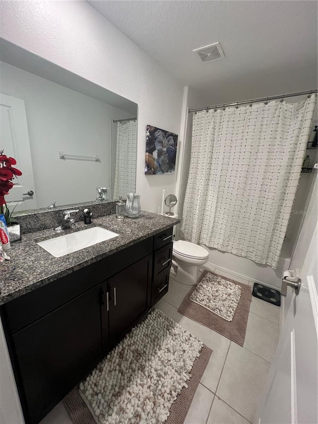 full bathroom featuring a textured ceiling, toilet, shower / bath combo, vanity, and tile patterned flooring