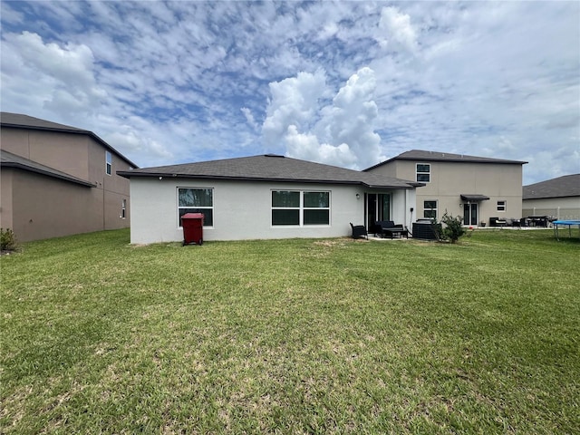 back of house with a lawn