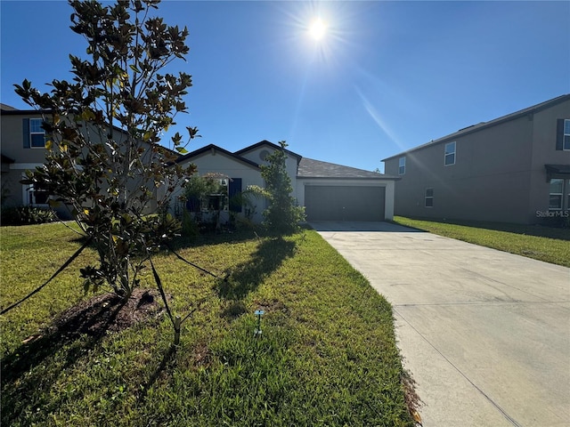 view of front of property featuring a front lawn and a garage