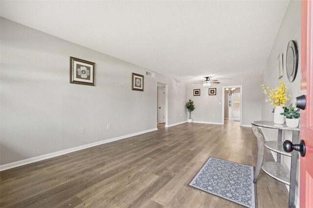 interior space with ceiling fan and wood-type flooring