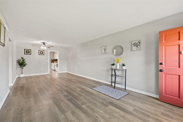 foyer entrance with ceiling fan and hardwood / wood-style flooring