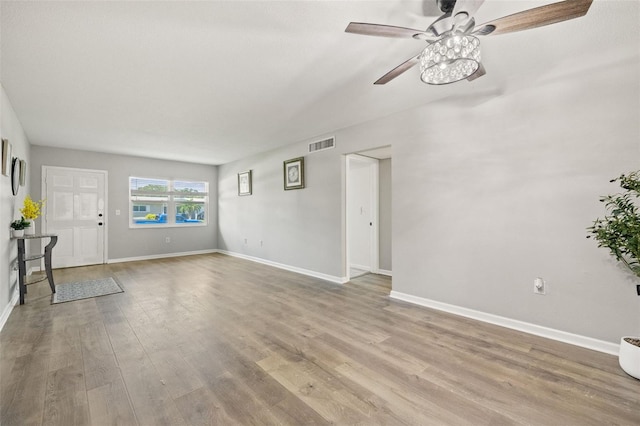 unfurnished living room with light wood-type flooring and ceiling fan