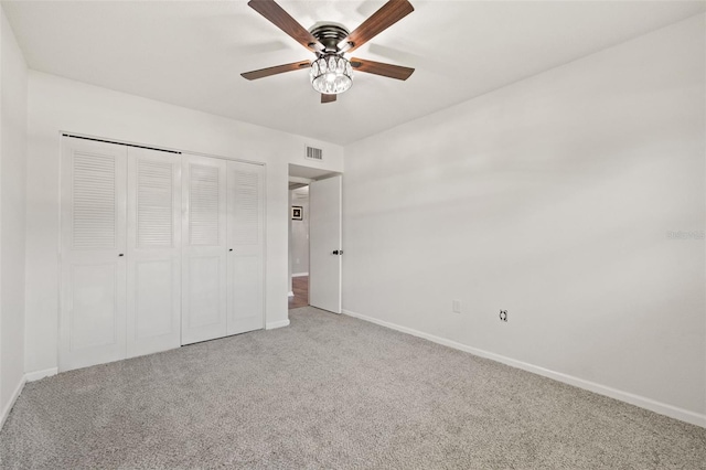 unfurnished bedroom with ceiling fan, a closet, and carpet