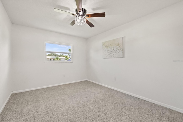 spare room with ceiling fan and carpet flooring