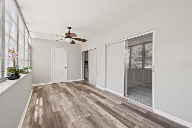 unfurnished room featuring ceiling fan and wood-type flooring