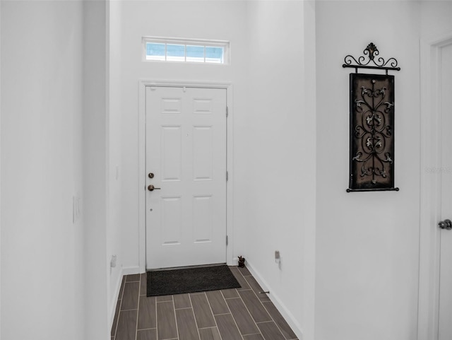 foyer entrance featuring wood finish floors and baseboards