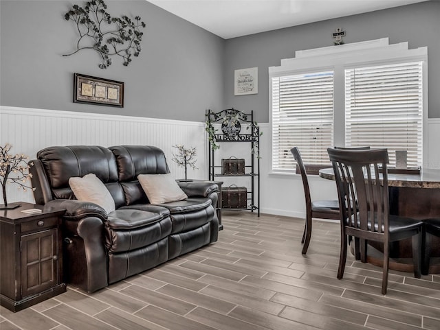 living area featuring a wainscoted wall and wood tiled floor