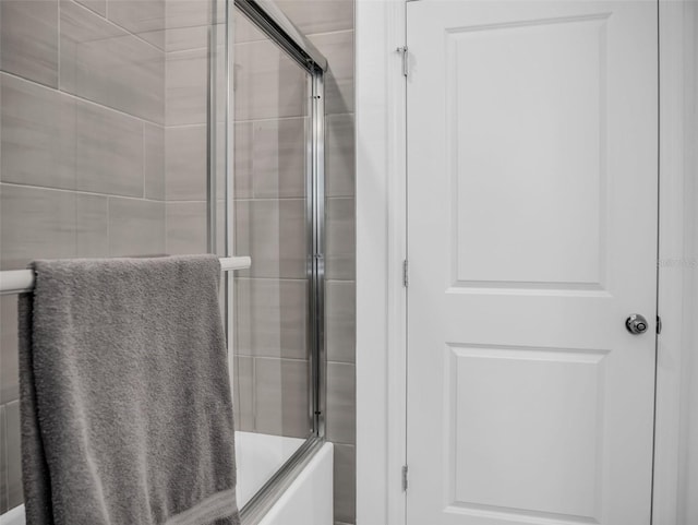 full bath featuring combined bath / shower with glass door