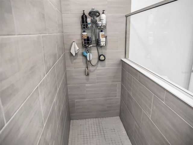 full bath with a tile shower