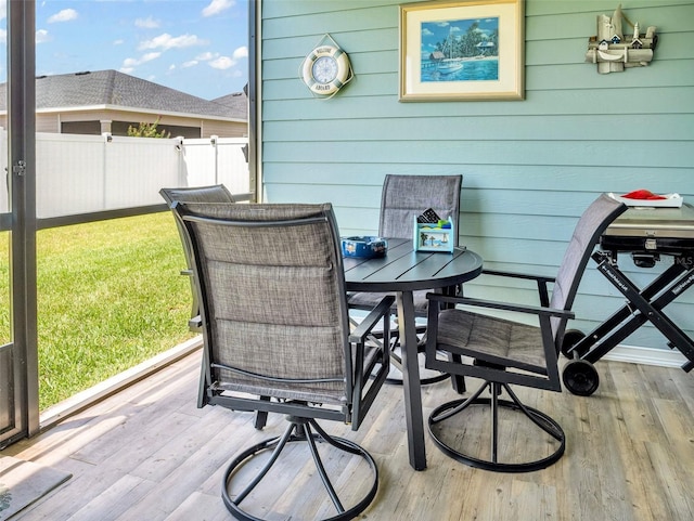 exterior space featuring outdoor dining area and fence