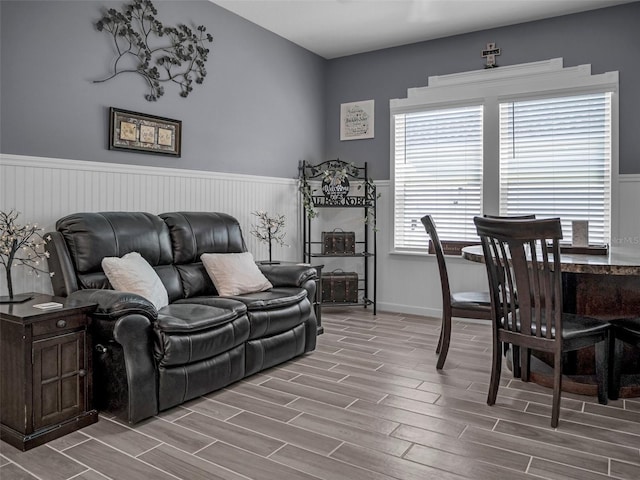 living area featuring wood finish floors and wainscoting