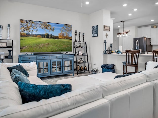 living area with light wood-style floors and recessed lighting