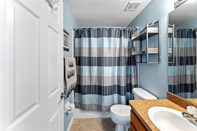 bathroom featuring a textured ceiling, toilet, tile patterned floors, and vanity