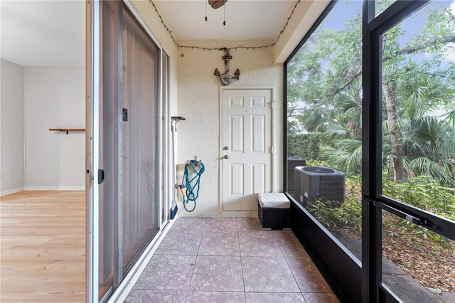 sunroom / solarium with ceiling fan and a healthy amount of sunlight