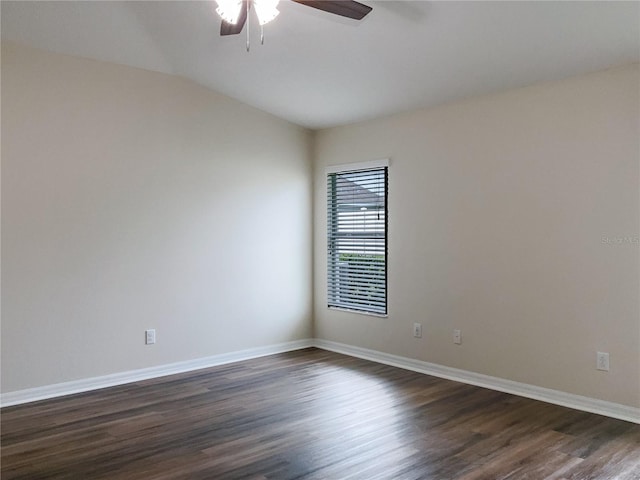 unfurnished room with vaulted ceiling, dark wood finished floors, baseboards, and ceiling fan