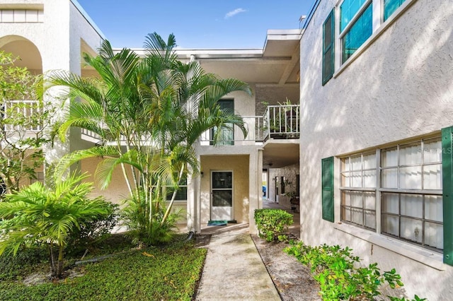 4335 Aegean Dr Unit 106A, Tampa, FL 33611 - doorway to property with a balcony and stucco siding