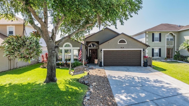 view of front of house featuring a front lawn and a garage