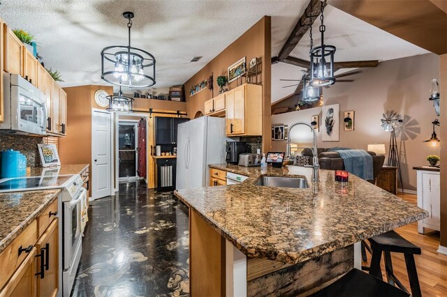 kitchen with dark hardwood / wood-style floors, sink, a textured ceiling, ceiling fan with notable chandelier, and white appliances