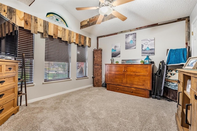 carpeted bedroom featuring ceiling fan, vaulted ceiling, and a textured ceiling