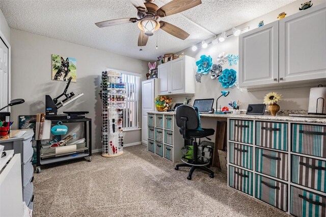 home office with ceiling fan, rail lighting, light colored carpet, and a textured ceiling