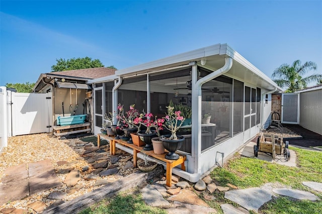 back of property featuring a patio and a sunroom