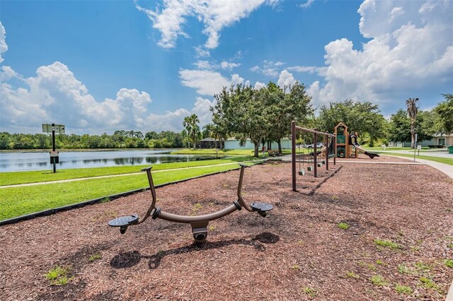 view of playground with a water view and a yard