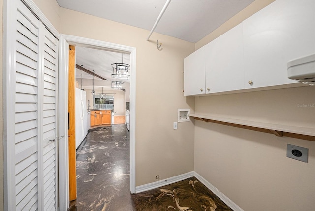 laundry area featuring washer hookup, cabinet space, electric dryer hookup, and baseboards