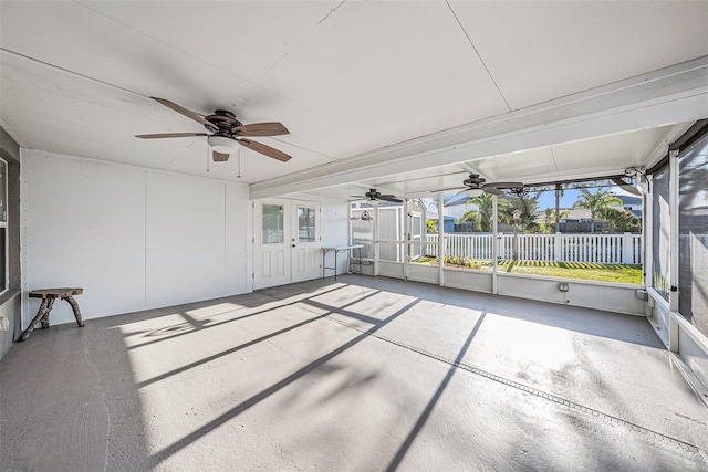 unfurnished sunroom with a ceiling fan