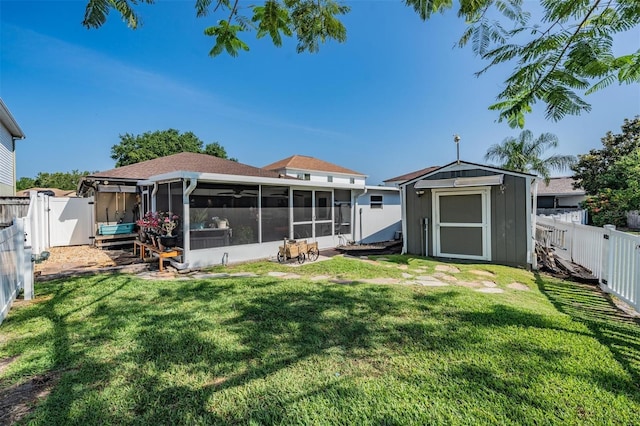 back of property with a fenced backyard, a storage unit, and a yard