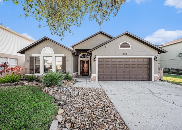 ranch-style house featuring concrete driveway, an attached garage, and stucco siding