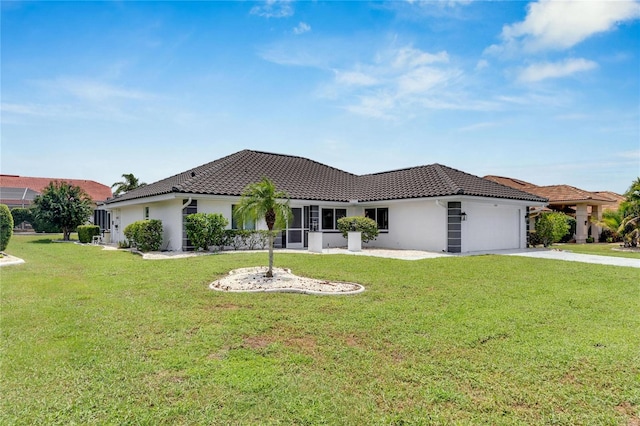 mediterranean / spanish house with a garage and a front lawn