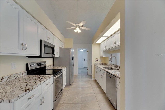 kitchen featuring light tile patterned flooring, sink, appliances with stainless steel finishes, ceiling fan, and white cabinets