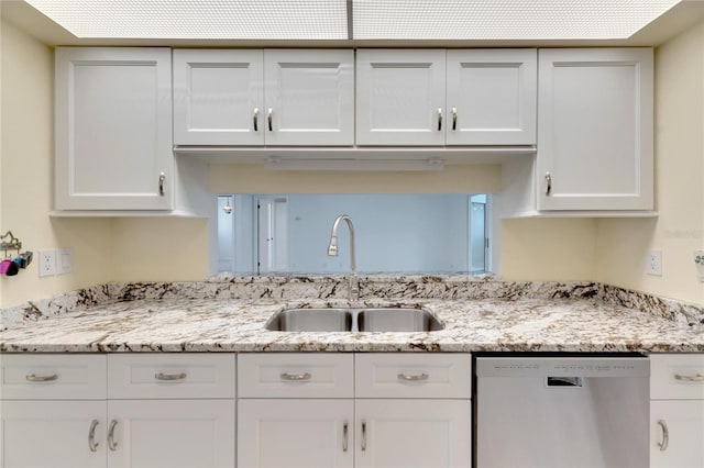 kitchen with sink, stainless steel dishwasher, white cabinetry, and light stone countertops