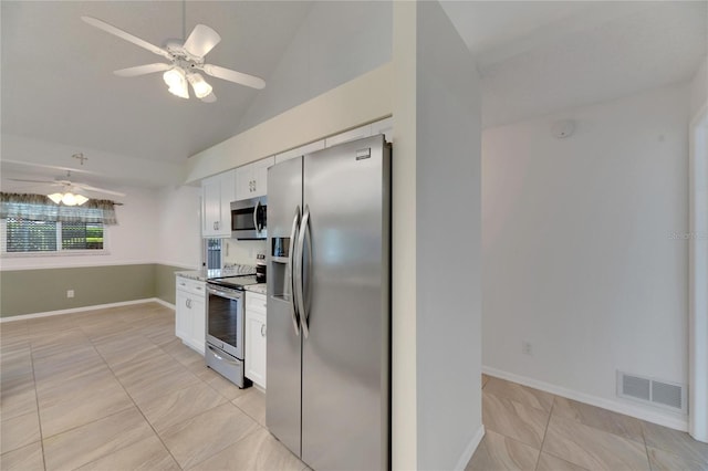 kitchen featuring ceiling fan, white cabinetry, light tile patterned floors, and stainless steel appliances