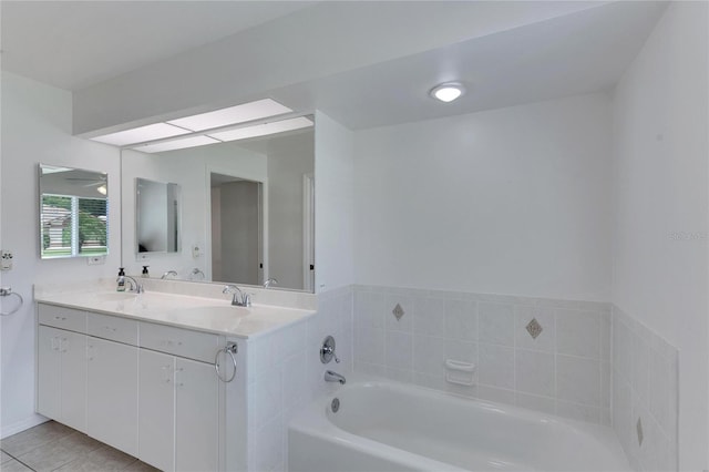 bathroom featuring a bath, tile patterned floors, dual vanity, and ceiling fan