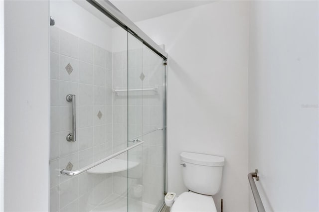 bathroom with toilet and walk in shower