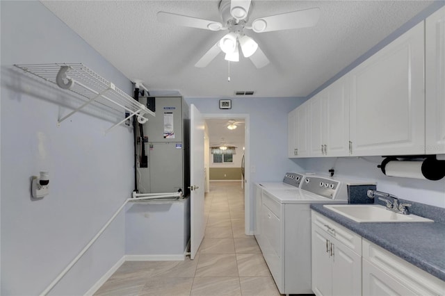 laundry area featuring sink, a textured ceiling, independent washer and dryer, ceiling fan, and light tile patterned flooring