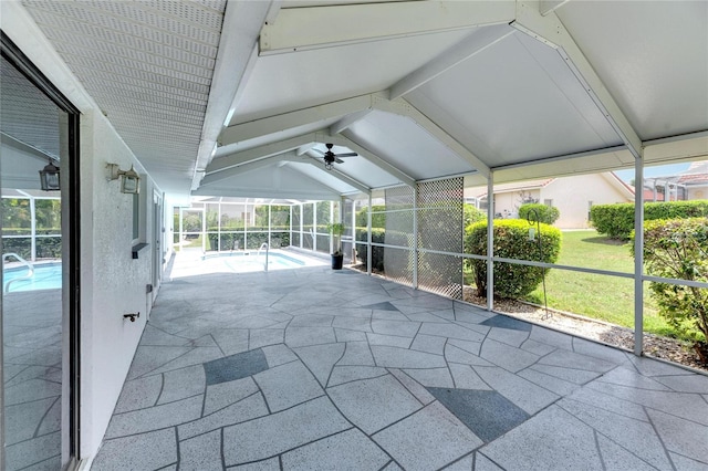 unfurnished sunroom featuring ceiling fan