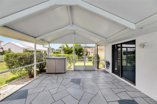 unfurnished sunroom with lofted ceiling