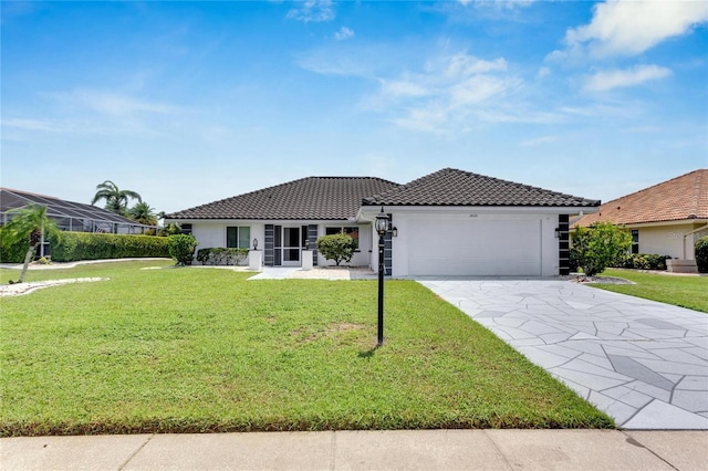 view of front of property featuring a garage and a front lawn