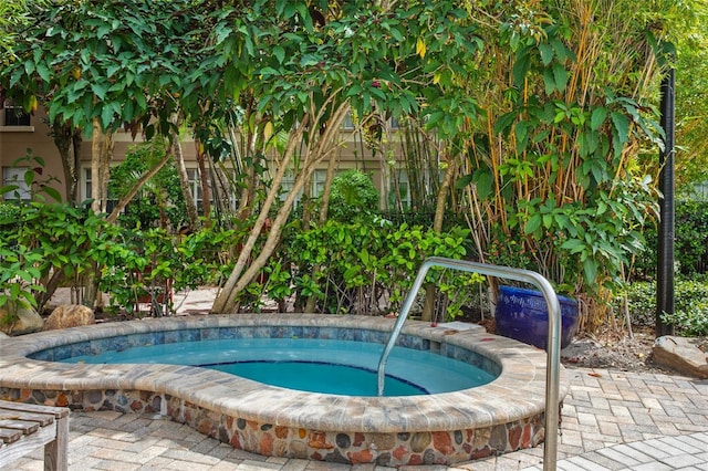 view of swimming pool with a patio and an in ground hot tub