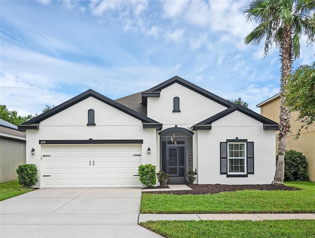 view of front of home featuring a front yard and a garage